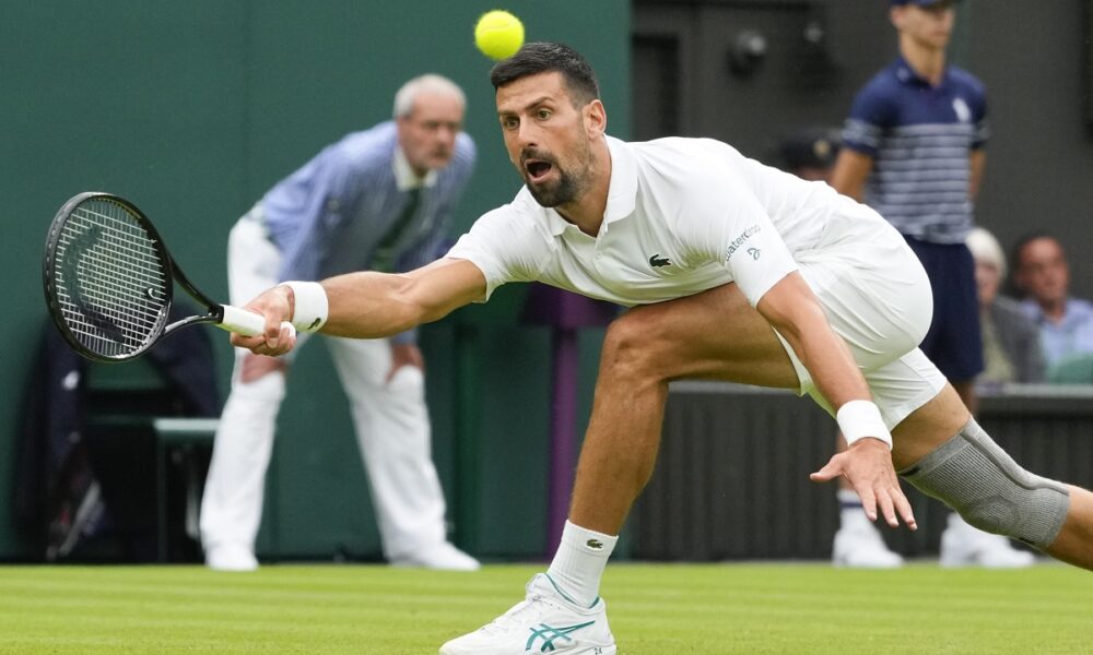 Serbia's Novak Djokovic plays a forehand return to Vit Kopriva of the Czech Republic during their first round match at the Wimbledon tennis championships in London, Tuesday, July 2, 2024. (AP Photo/Kirsty Wigglesworth)