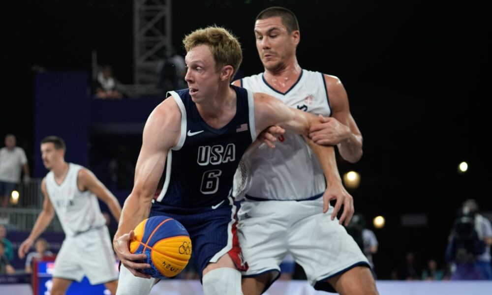 Canyon Barry of the United States fends off Mihailo Vasic of Serbia in the men's 3x3 basketball pool round match between Serbia and the United States at the 2024 Summer Olympics, Tuesday, July 30, 2024, in Paris, France. (AP Photo/Rebecca Blackwell)