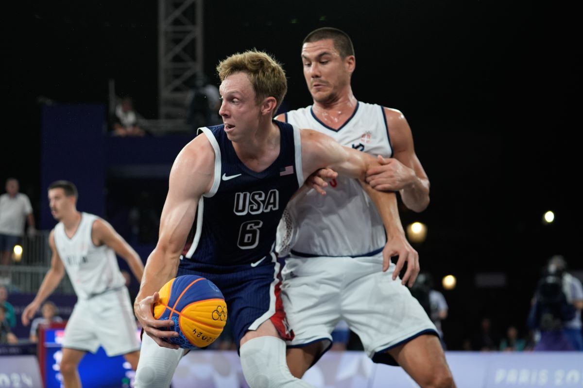 Canyon Barry of the United States fends off Mihailo Vasic of Serbia in the men's 3x3 basketball pool round match between Serbia and the United States at the 2024 Summer Olympics, Tuesday, July 30, 2024, in Paris, France. (AP Photo/Rebecca Blackwell)