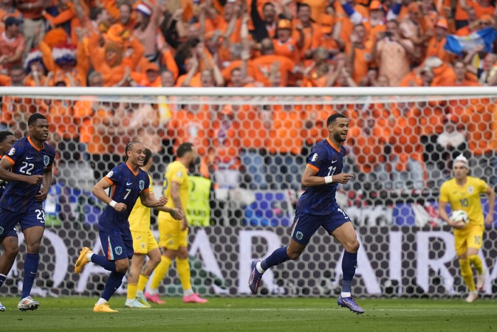 Cody Gakpo of the Netherlands celebrates scoring his side's opening goal during a round of sixteen match between Romania and the Netherlands at the Euro 2024 soccer tournament in Munich, Germany, Tuesday, July 2, 2024. (AP Photo/Matthias Schrader)