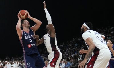 Serbia's Nikola Jokic, left, attempts to score as United States' Bam Adebayo blocks during an exhibition basketball match between Serbia and the United States at the USA Basketball Showcase, ahead of the 2024 Paris Olympic basketball tournament, in Abu Dhabi, United Arab Emirates, Wednesday, July 17, 2024. (AP Photo/Altaf Qadri)