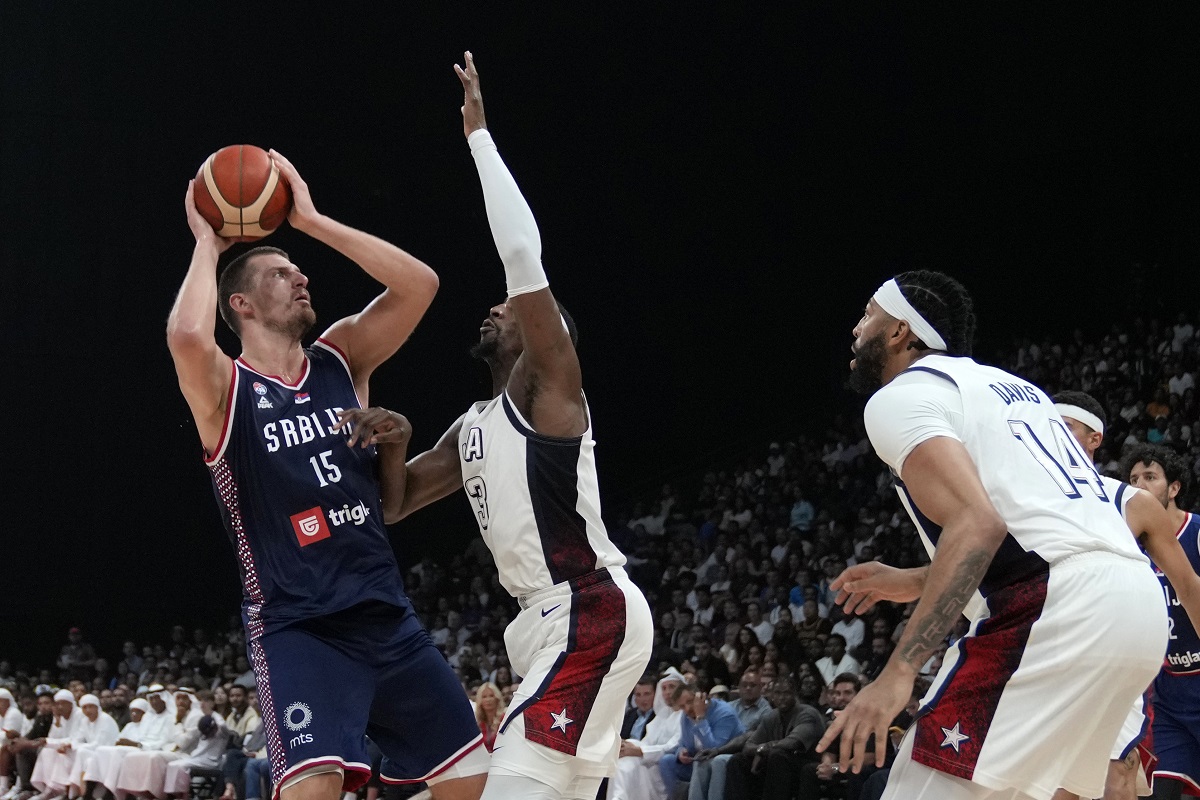 Serbia's Nikola Jokic, left, attempts to score as United States' Bam Adebayo blocks during an exhibition basketball match between Serbia and the United States at the USA Basketball Showcase, ahead of the 2024 Paris Olympic basketball tournament, in Abu Dhabi, United Arab Emirates, Wednesday, July 17, 2024. (AP Photo/Altaf Qadri)