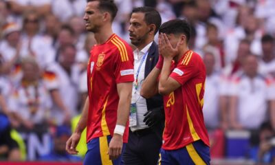 Spain's Pedri, right, covers his face after suffering an injury during a quarter final match between Germany and Spain at the Euro 2024 soccer tournament in Stuttgart, Germany, Friday, July 5, 2024. (AP Photo/Manu Fernandez)