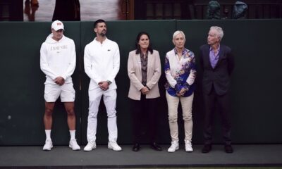 CAPTION CORRECTS ID Current and former players, from left, Holger Rune, Novak Djokovic, Conchita Martinez, Martina Navratilova, and John McEnroe listen to Britain's Andy Murray as he speaks with Sue Barker following his first round doubles match with this brother Jamie against Australia's John Peers and Ricky Hijikata at the Wimbledon tennis championships in London, Thursday, July 4, 2024. (John Walton/PA via AP)