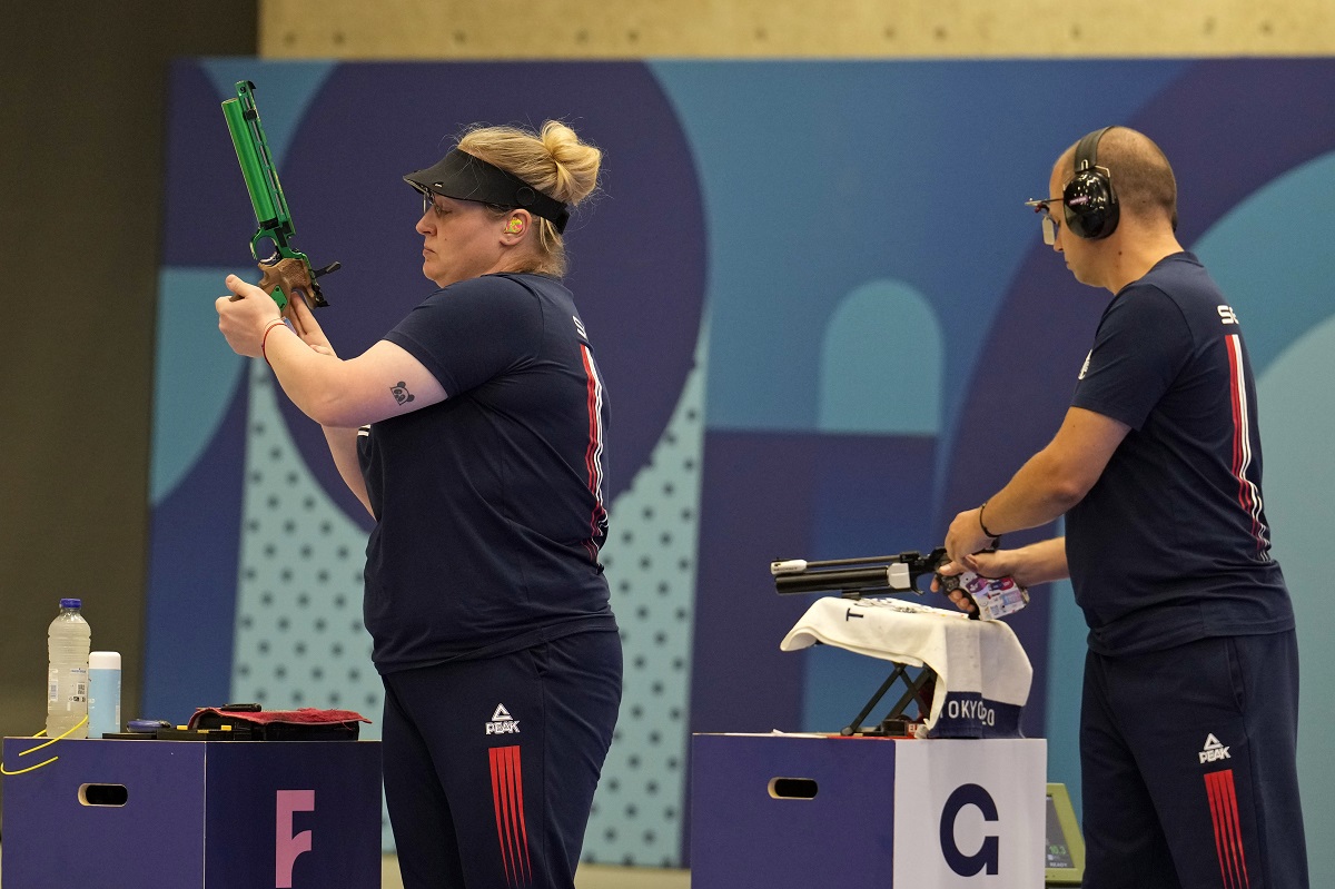 Serbia's Zorana Arunovic, left, and Damir Mikec get ready to compete in the 10m air pistol mixed team gold medal event at the 2024 Summer Olympics, Tuesday, July 30, 2024, in Chateauroux, France. (AP Photo/Manish Swarup)