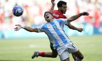 Argentina's Giuliano Simeone, front, and Morocco's Zakaria El Ouahdi fight for the ball during the men's Group B soccer match between Argentina and Morocco at Geoffroy-Guichard Stadium at the 2024 Summer Olympics, Wednesday, July 24, 2024, in Saint-Etienne, France. (AP Photo/Silvia Izquierdo)