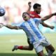 Argentina's Giuliano Simeone, front, and Morocco's Zakaria El Ouahdi fight for the ball during the men's Group B soccer match between Argentina and Morocco at Geoffroy-Guichard Stadium at the 2024 Summer Olympics, Wednesday, July 24, 2024, in Saint-Etienne, France. (AP Photo/Silvia Izquierdo)