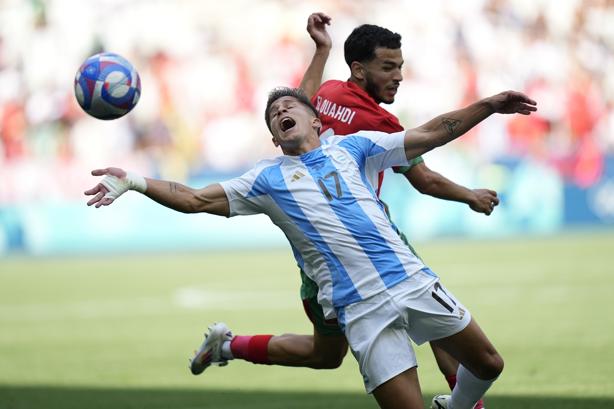 Argentina's Giuliano Simeone, front, and Morocco's Zakaria El Ouahdi fight for the ball during the men's Group B soccer match between Argentina and Morocco at Geoffroy-Guichard Stadium at the 2024 Summer Olympics, Wednesday, July 24, 2024, in Saint-Etienne, France. (AP Photo/Silvia Izquierdo)