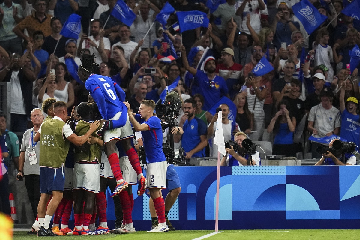 France players celebrate after Alexandre Lacazette scored his side's first goal during the men's Group A soccer match between France and the United States at the Velodrome stadium, during the 2024 Summer Olympics, Wednesday, July 24, 2024, in Marseille, France. (AP Photo/Daniel Cole)