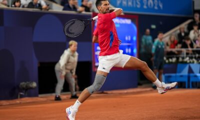 Serbian tennis player Novak Djokovic returns the ball against Matthew Ebden of Australia during the men's singles tennis competition, at the 2024 Summer Olympics, Saturday, July 27, 2024, in Paris, France. (AP Photo/Manu Fernandez)