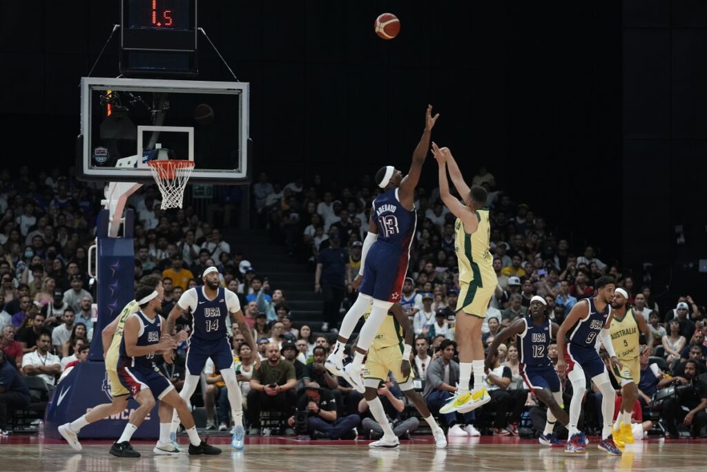 Australia's Dante Exum, right, shoots as USA's Bam Adebayo tries to block during the USA Basketball Showcase in Abu Dhabi, United Arab Emirates, Monday, July 15, 2024. (AP Photo/Altaf Qadri)