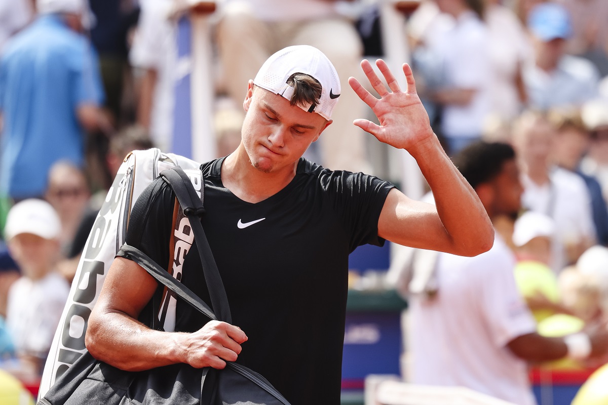 Denmark's Holger Rune looks dejected after retiring during his quarter final match against France's Arthur Fils, at the Hamburg ATP, Germany, Friday July 19, 2024. (Frank Molter/dpa via AP)