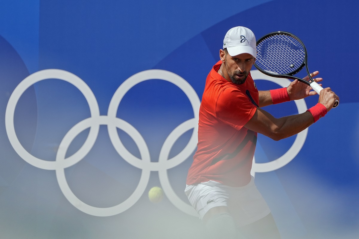 Novak Djokovic of Serbia returns the ball during a practice session ahead of the tennis competition, at the 2024 Summer Olympics, Thursday, July 25, 2024, in Paris, France. (AP Photo/Andy Wong)