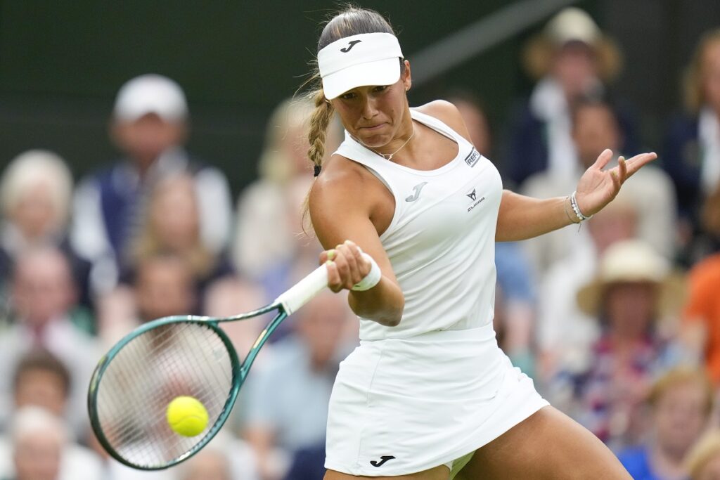 Jessica Bouzas Maneiro of Spain plays a forehand return to Marketa Vondrousova of the Czech Republic during their first round match at the Wimbledon tennis championships in London, Tuesday, July 2, 2024. (AP Photo/Kirsty Wigglesworth)