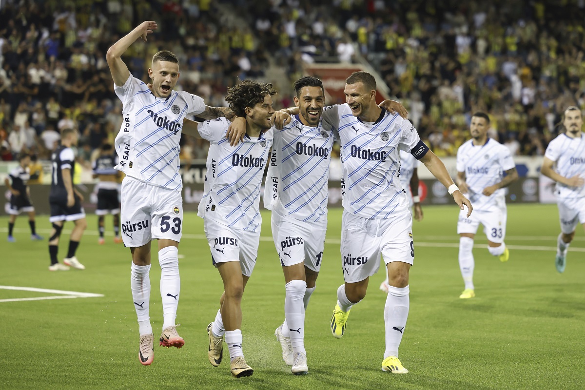 Fenerbahce players, from left, Sebastian Szymanski, Ferdi Kadioglu, Ifran Can Kahveci and Edin Dzeko celebrate after Ferdi Kadioglu scored his side's fourth goal during a UEFA Champions League qualifying second round first leg soccer match between Switzerland's FC Lugano and Turkey's Fenerbahce Istanbul at the Stockhorn Arena in Thun, Switzerland, Tuesday, July 23, 2024. (Peter Klaunzer/Keystone via AP)