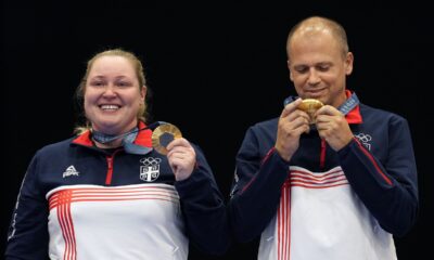 Serbia's Zorana Arunovic, left, and Serbia's Damir Mikec pose for a photograph after winning the gold medal in the 10m air pistol mixed team event at the 2024 Summer Olympics, Tuesday, July 30, 2024, in Chateauroux, France. (AP Photo/Manish Swarup)