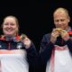 Serbia's Zorana Arunovic, left, and Serbia's Damir Mikec pose for a photograph after winning the gold medal in the 10m air pistol mixed team event at the 2024 Summer Olympics, Tuesday, July 30, 2024, in Chateauroux, France. (AP Photo/Manish Swarup)