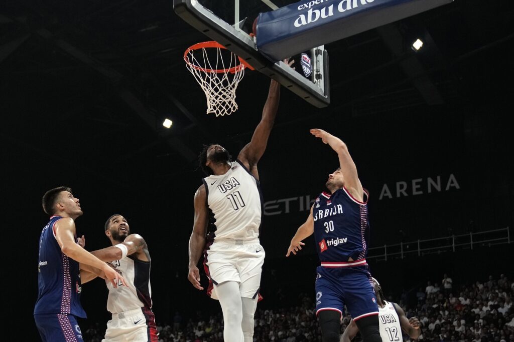 Serbia's Aleksa Avramovic, right, scores during an exhibition basketball match between Serbia and the United States at the USA Basketball Showcase, ahead of the 2024 Paris Olympic basketball tournament, in Abu Dhabi, United Arab Emirates, Wednesday, July 17, 2024. (AP Photo/Altaf Qadri)