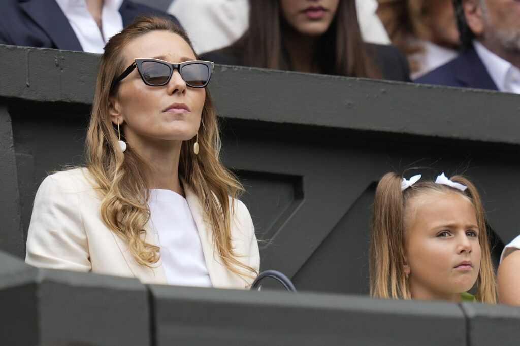 Jelena Djokovic and her daughter Tara watch Novak Djokovic of Serbia play Carlos Alcaraz of Spain in the men's singles final at the Wimbledon tennis championships in London, Sunday, July 14, 2024. (AP Photo/Kirsty Wigglesworth)