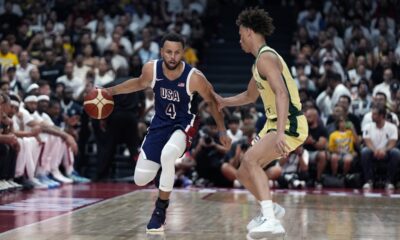 Team USA's Stephen Curry (4) drives on Australia's Dyson Daniels during the USA Basketball Showcase in Abu Dhabi, United Arab Emirates, Monday, July 15, 2024. (AP Photo/Altaf Qadri)