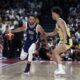 Team USA's Stephen Curry (4) drives on Australia's Dyson Daniels during the USA Basketball Showcase in Abu Dhabi, United Arab Emirates, Monday, July 15, 2024. (AP Photo/Altaf Qadri)