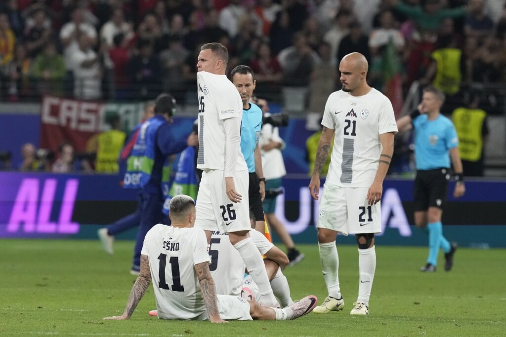 Slovenia's players react at the end of the penalties shootouts during a round of sixteen match against Portugal at the Euro 2024 soccer tournament in Frankfurt, Germany, Monday, July 1, 2024. (AP Photo/Antonio Calanni)