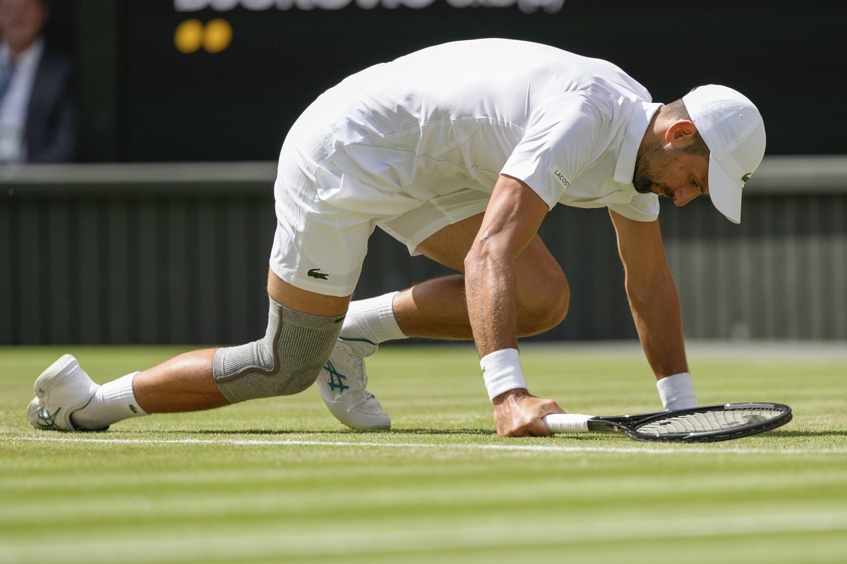Serbia's Novak Djokovic falls during his second round match against Britain's Jacob Fearnley at the Wimbledon tennis championships in London, Thursday, July 4, 2024. (AP Photo/Kirsty Wigglesworth)
