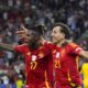 Spain's Mikel Oyarzabal celebrates with Nico Williams, left, after scoring his side's second goal during the final match between Spain and England at the Euro 2024 soccer tournament in Berlin, Germany, Sunday, July 14, 2024. (AP Photo/Manu Fernandez)