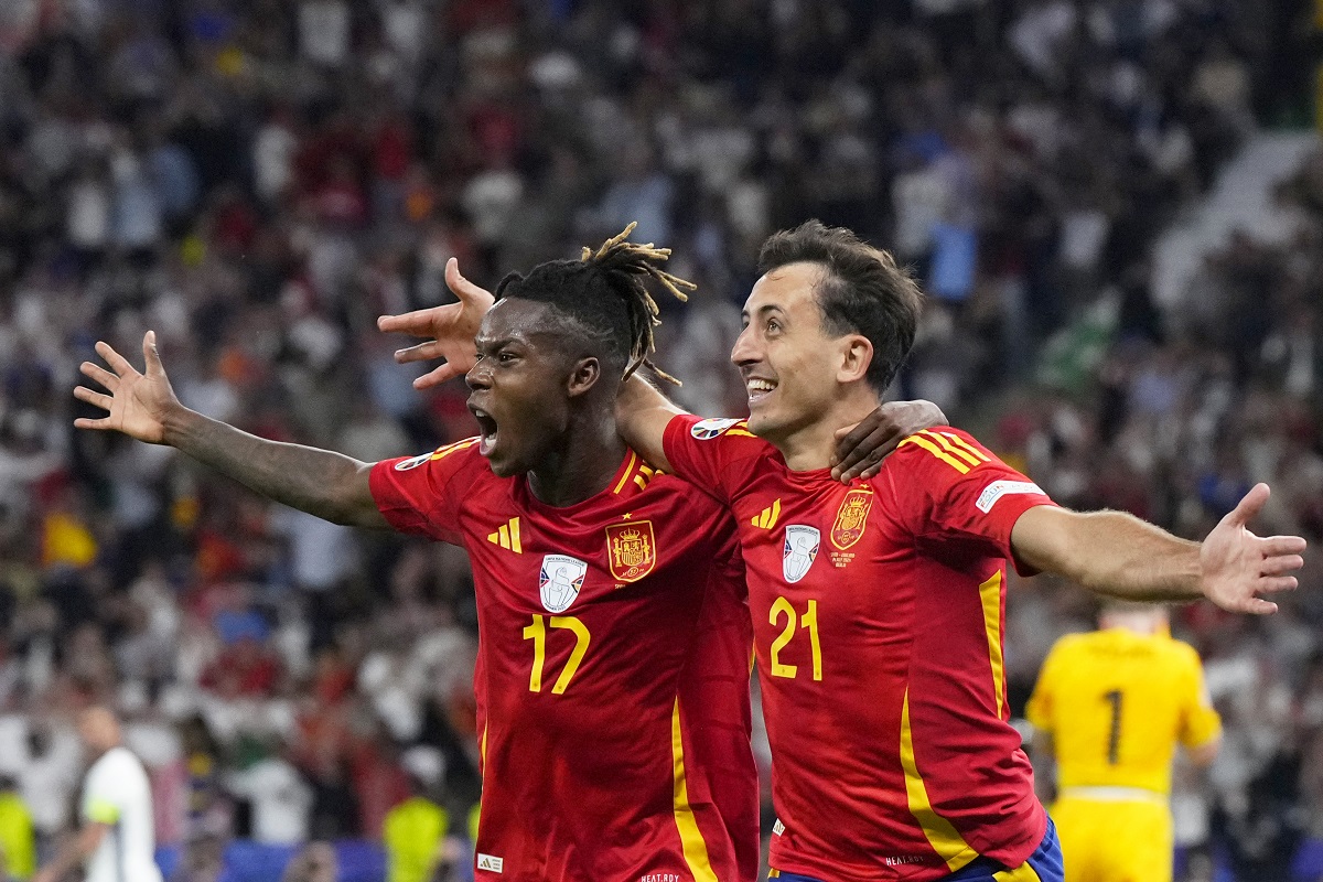 Spain's Mikel Oyarzabal celebrates with Nico Williams, left, after scoring his side's second goal during the final match between Spain and England at the Euro 2024 soccer tournament in Berlin, Germany, Sunday, July 14, 2024. (AP Photo/Manu Fernandez)