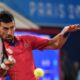 Serbian tennis player Novak Djokovic returns the ball against Matthew Ebden of Australia during the men's singles tennis competition, at the 2024 Summer Olympics, Saturday, July 27, 2024, in Paris, France. (AP Photo/Manu Fernandez)