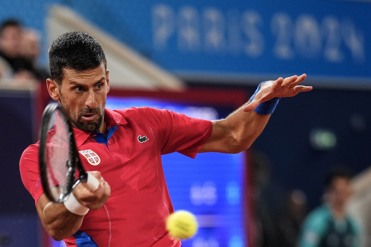 Serbian tennis player Novak Djokovic returns the ball against Matthew Ebden of Australia during the men's singles tennis competition, at the 2024 Summer Olympics, Saturday, July 27, 2024, in Paris, France. (AP Photo/Manu Fernandez)