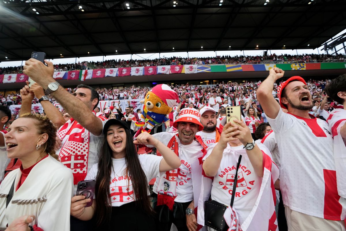 Georgia fans cheer during a round of sixteen match between Spain and Georgia at the Euro 2024 soccer tournament in Cologne, Germany, Sunday, June 30, 2024. (AP Photo/Martin Meissner)