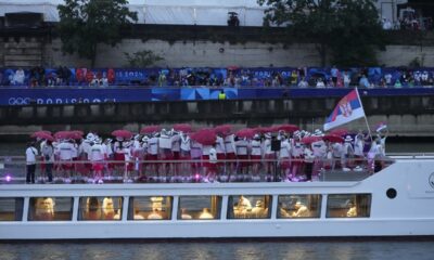 Serbia team parades along the Seine river in Paris, France, during the opening ceremony of the 2024 Summer Olympics, Friday, July 26, 2024. (AP Photo/Charlie Riedel)