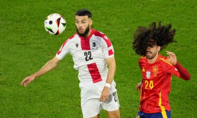 Georgia's Georges Mikautadze, left, controls the ball next to Spain's Marc Cucurella during a round of sixteen match at the Euro 2024 soccer tournament in Cologne, Germany, Sunday, June 30, 2024. (AP Photo/Andreea Alexandru)