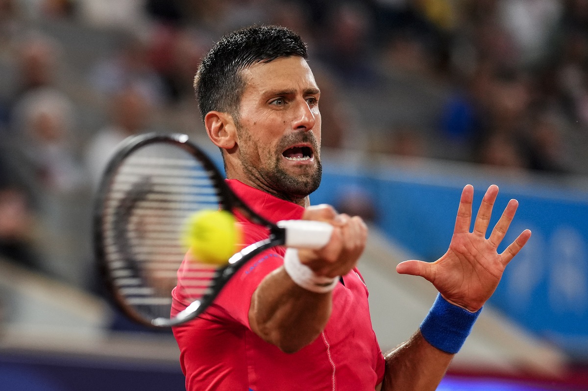 Serbian tennis player Novak Djokovic returns the ball against Matthew Ebden of Australia during the men's singles tennis competition, at the 2024 Summer Olympics, Saturday, July 27, 2024, in Paris, France. (AP Photo/Manu Fernandez)