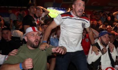 England fans react as they watch on the Euro 2024 final soccer against Spain at a pub in Hebburn, England, Sunday, July 14, 2024. The match is being played in Berlin. (AP Photo/Scott Heppell)