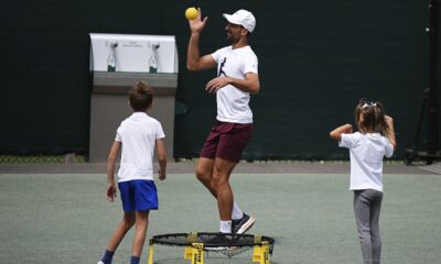 Serbia's Novak Djokovic plays a game of Spike Ball with his children before training, at the Wimbledon tennis championships in London, Saturday, July 13, 2024. (Aaron Chown/PA via AP)