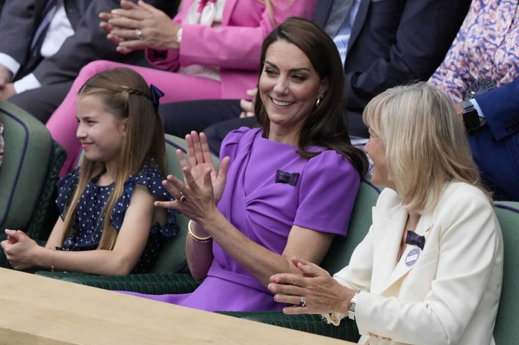 Kate, Princess of Wales, center, and her daughter Princess Charlotte, left, watch the men's singles final between Carlos Alcaraz of Spain and Novak Djokovic of Serbia, from the Royal Box at the Wimbledon tennis championships in London, Sunday, July 14, 2024. (AP Photo/Mosa'ab Elshamy)