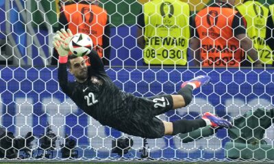 Portugal's goalkeeper Diogo Costa saves the ball during penalties of a round of sixteen match between Portugal and Slovenia at the Euro 2024 soccer tournament in Frankfurt, Germany, Monday, July 1, 2024. (AP Photo/Ebrahim Noroozi)