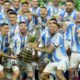 Argentina players Angel di Maria, left, Lionel Messi, second from left, and Nicolas Otamendi, third from left, celebrate with the trophy after defeating Colombia in the Copa America final soccer match in Miami Gardens, Fla., Monday, July 15, 2024. (AP Photo/Rebecca Blackwell)