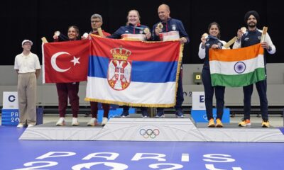 L to R on the podium, Turkey's Savval Ilayda Tarhan and Yususf Dikec, Serbia's Zorana Arunovic and Damir Mikec, and India's Manu Bhaker and Sarabjot Singh pose for a photograph after the medal ceremony of the 10m air pistol mixed team event at the 2024 Summer Olympics, Tuesday, July 30, 2024, in Chateauroux, France. Serbia won the gold medal, while Turkey and India won the silver and the bronze respectively. (AP Photo/Manish Swarup)