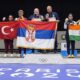 L to R on the podium, Turkey's Savval Ilayda Tarhan and Yususf Dikec, Serbia's Zorana Arunovic and Damir Mikec, and India's Manu Bhaker and Sarabjot Singh pose for a photograph after the medal ceremony of the 10m air pistol mixed team event at the 2024 Summer Olympics, Tuesday, July 30, 2024, in Chateauroux, France. Serbia won the gold medal, while Turkey and India won the silver and the bronze respectively. (AP Photo/Manish Swarup)