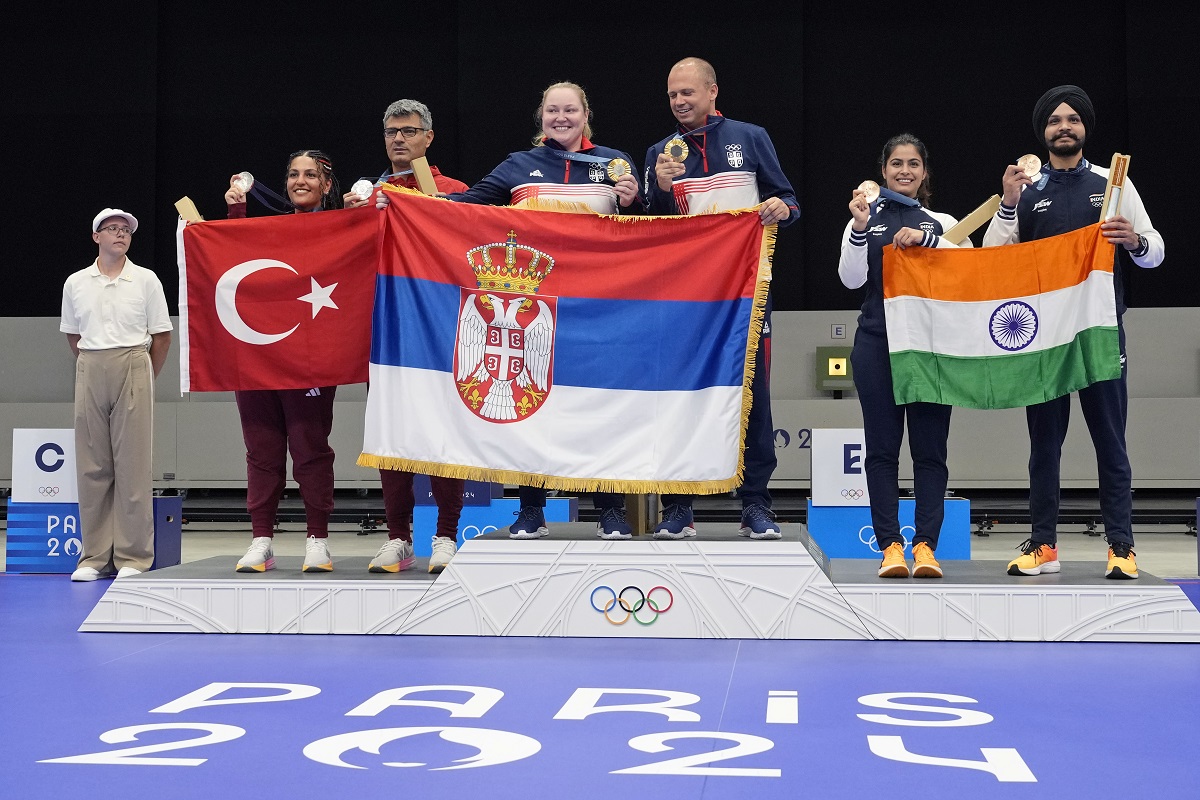 L to R on the podium, Turkey's Savval Ilayda Tarhan and Yususf Dikec, Serbia's Zorana Arunovic and Damir Mikec, and India's Manu Bhaker and Sarabjot Singh pose for a photograph after the medal ceremony of the 10m air pistol mixed team event at the 2024 Summer Olympics, Tuesday, July 30, 2024, in Chateauroux, France. Serbia won the gold medal, while Turkey and India won the silver and the bronze respectively. (AP Photo/Manish Swarup)