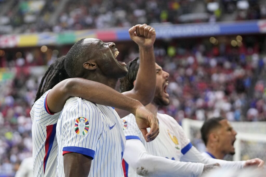 Randal Kolo Muani of France, foreground, and his teammates celebrate their side's first goal during a round of sixteen match between France and Belgium at the Euro 2024 soccer tournament in Duesseldorf, Germany, Monday, July 1, 2024. (AP Photo/Darko Vojinovic)