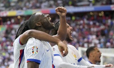 Randal Kolo Muani of France, foreground, and his teammates celebrate their side's first goal during a round of sixteen match between France and Belgium at the Euro 2024 soccer tournament in Duesseldorf, Germany, Monday, July 1, 2024. (AP Photo/Darko Vojinovic)
