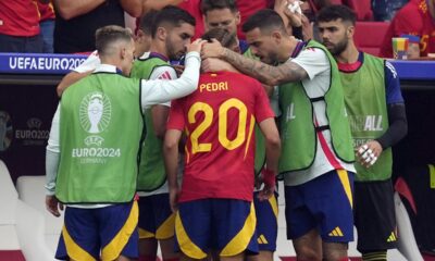 Spain's Pedri (20) is consoled by teammates after he was taken out of the game following an injury in a quarterfinal match between Germany and Spain at the Euro 2024 soccer tournament in Stuttgart, Germany, Friday, July 5, 2024. (AP Photo/Antonio Calanni)