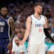 Marko Guduric, right, of Serbia, complains about being called for a foul as LeBron James, of the United States, looks on in a men's basketball game at the 2024 Summer Olympics, Sunday, July 28, 2024, in Villeneuve-d'Ascq, France. (AP Photo/Michael Conroy)