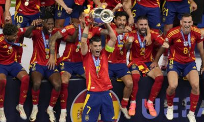 Spain's Alvaro Morata lifts the trophy after winning the final match between Spain and England at the Euro 2024 soccer tournament in Berlin, Germany, Sunday, July 14, 2024. (AP Photo/Andreea Alexandru)