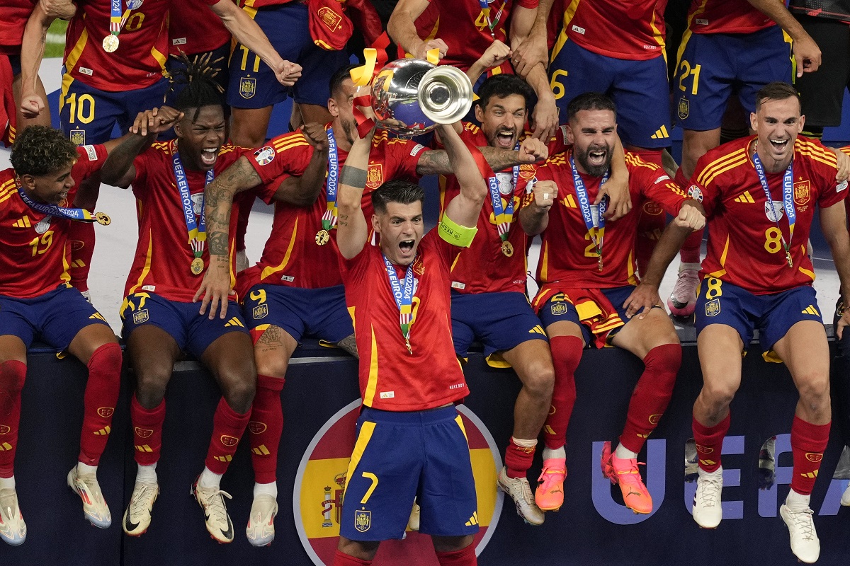 Spain's Alvaro Morata lifts the trophy after winning the final match between Spain and England at the Euro 2024 soccer tournament in Berlin, Germany, Sunday, July 14, 2024. (AP Photo/Andreea Alexandru)