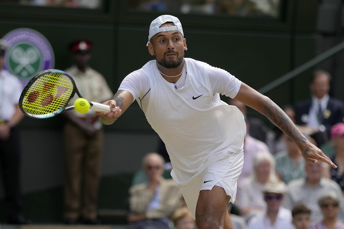 FILE - Australia's Nick Kyrgios returns to Serbia's Novak Djokovic in the final of the men's singles on the 14th day of the Wimbledon tennis championships in London, July 10, 2022. Kyrgios has played just one official singles match since October 2022 because of injuries, but Djokovic said Friday. July 12, 2024, that Kyrgios told him a return might happen at the U.S. Open. (AP Photo/Alastair Grant, File)